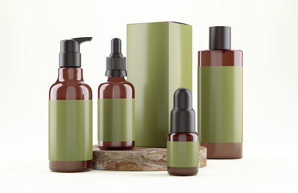 A group of four beauty product bottles and one matching box, all with a striking green label (which in this photo does not show a brand mark or name). This represents the option of producing private label health & beauty products with a contract manufacturing organization.