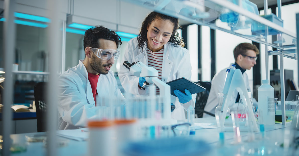 A diverse group of scientists and lab tech work together in a laboratory setting at a Contract Management Organization to drive innovation in personal care.
