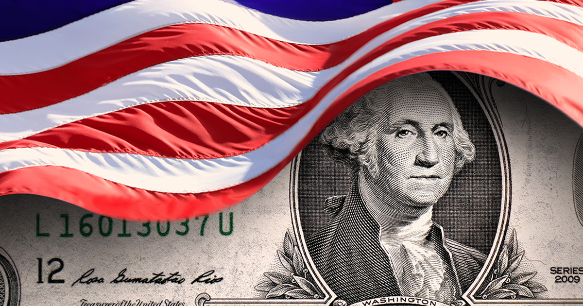 An American flag waves over a detailed closeup image of an American Dollar Bill, an image meant to invoke the discussion of cost savings of domestic production